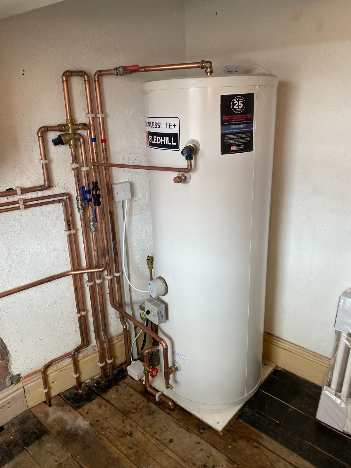 Domestic hot water cylinder and plumbing system